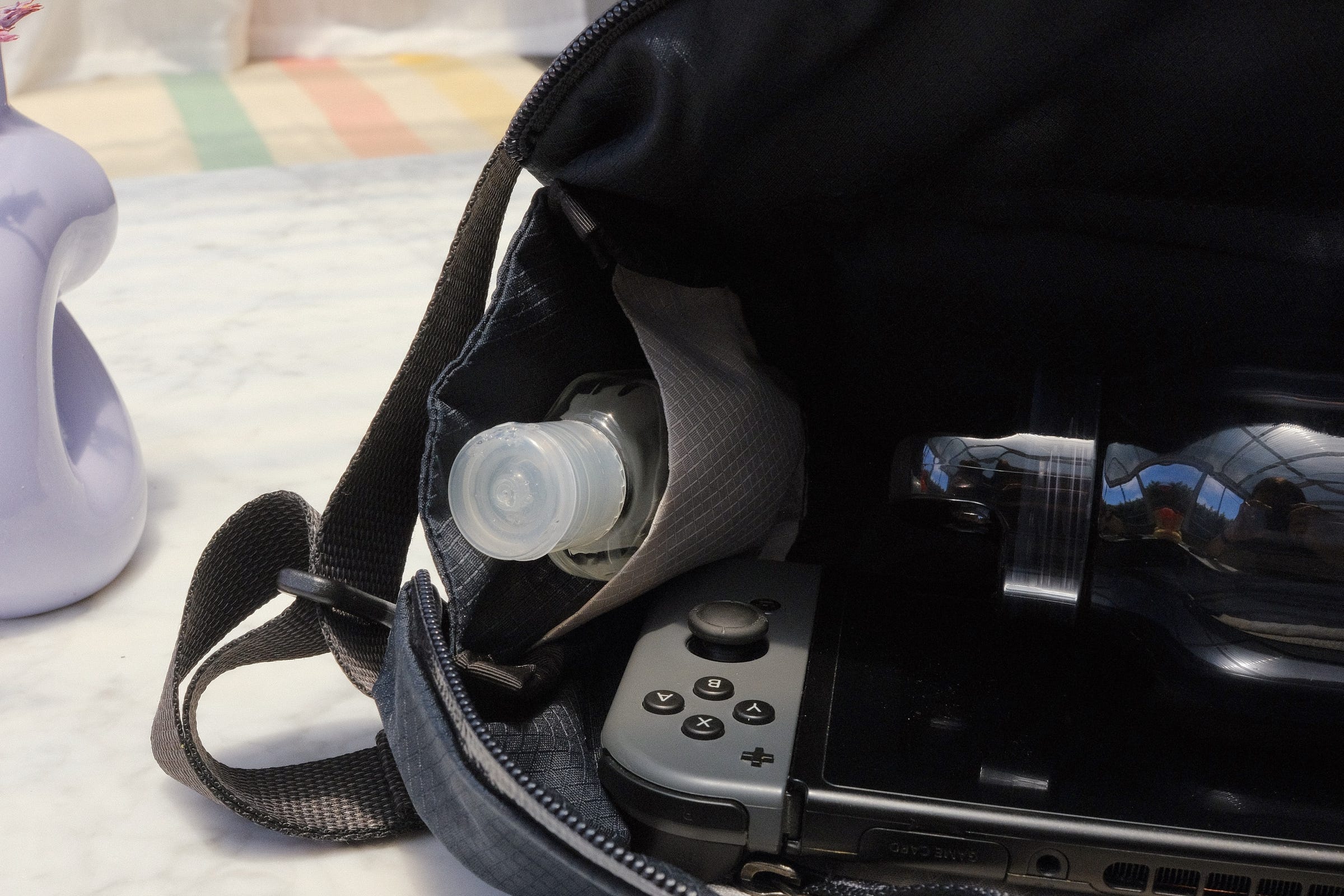 Main compartment on slate Bellroy Lite Sling and its small pocket